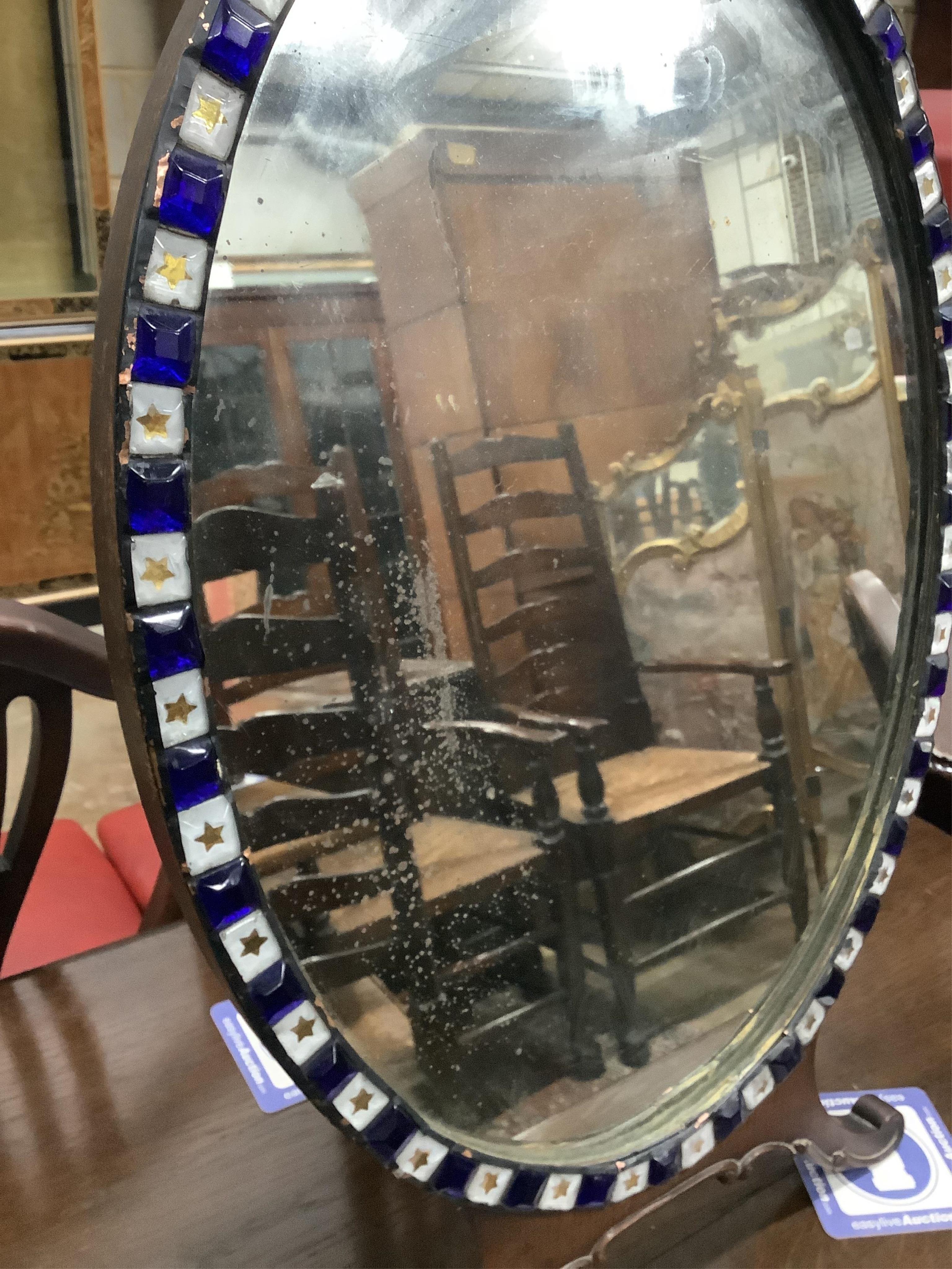 An early 20th century Irish glass bead applied mahogany toilet mirror, modelled in the 18th century manner and with label for M Butler of Dublin, width 40cm, height 62cm. Condition - fair